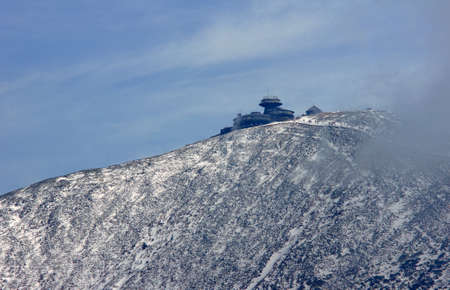 Snow-covered mountain slope and shelter in the Giant Mountains, Polandの写真素材