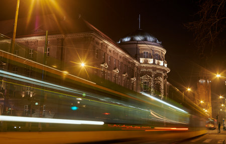 Tram in front of the Medical University in Pozna at nightのeditorial素材