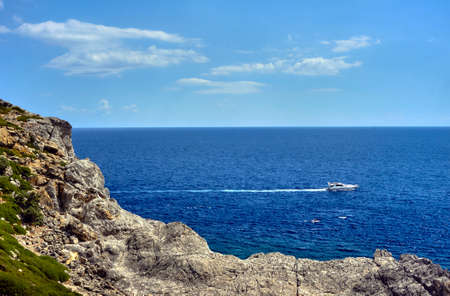 motorboat on the rocky coast of the island of Rhodes
