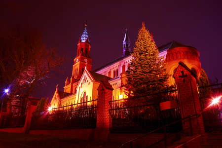Romanesque brick Catholic church at night in Poznan