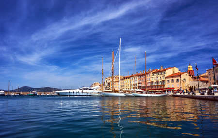 Sailboats and yachts moored to the quay port of Saint-Tropez, Franceの写真素材