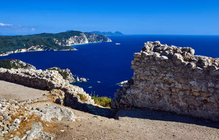 The ruined walls of the Byzantine castle over the bay on the island of Corfu in Greeceの写真素材