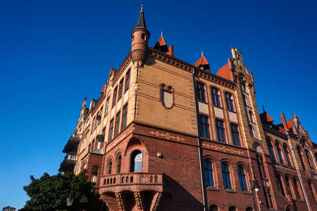 The facade of red brick building in Poznan