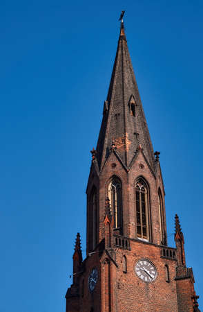 Gothic church tower with clock in Poznanの写真素材