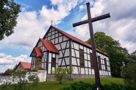 Cross and half-timbered country church in Polandの写真素材