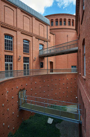 The metal structure transitions and brick wall in an old brewery in Poznanの写真素材