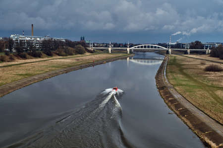Motorboat and bridge over the river Warta Poznanの写真素材