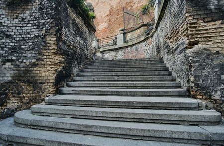 Wall made of brick and stone stairs in the old town in Poznanの写真素材
