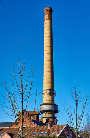 The chimney of a brick in an old gasworks in Poznanの写真素材