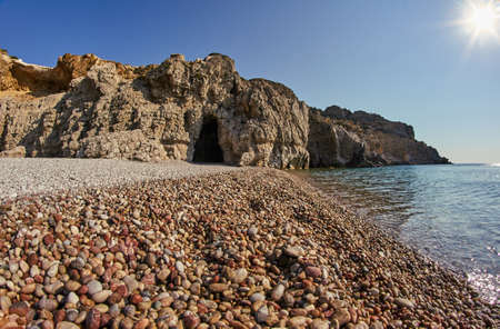 Rock and cave on the rocky beach of the Mediterranean Sea, on the island of Rhodesの写真素材