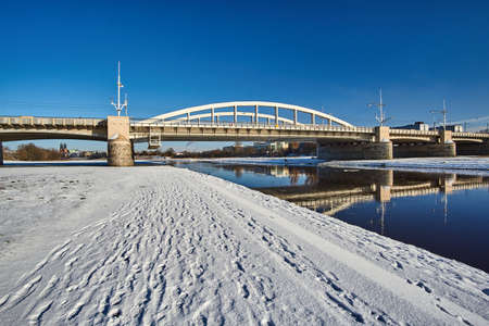 Urban landscape with river Warta bridge in winter in Poznanの写真素材