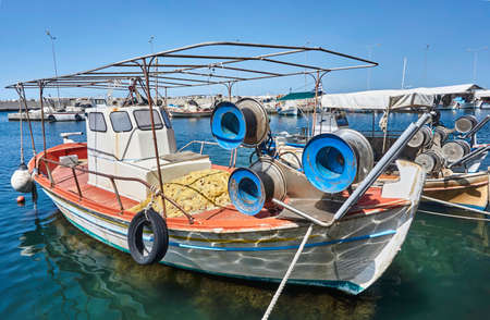 Fishing boats in the harbor on the coast of the Aegean Sea in Greeceの写真素材