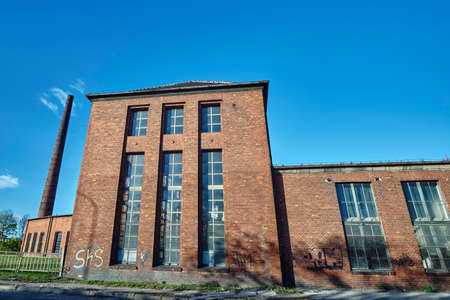 Brick chimney and buildings abandoned roundhouse in Gniezno in Polandの写真素材