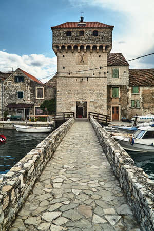 A stone, historic castle and bridge in the town of Kastel in Croatiaの写真素材