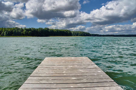 A wooden pier on a lake in Polandの写真素材