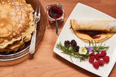 Plate with pancake and fruit on a wooden table topの写真素材