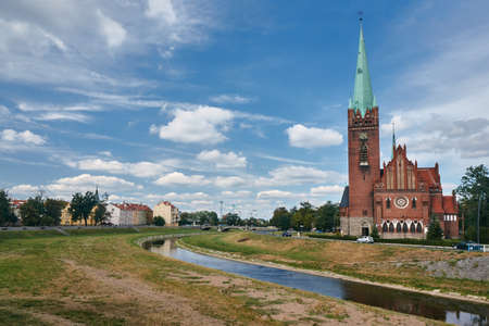 the river and neo-Gothic church with belfry in Legnica in Poland