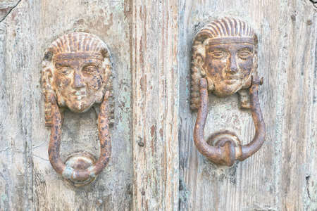 Antique, metal knockers on the old door of the city of Lindosの写真素材