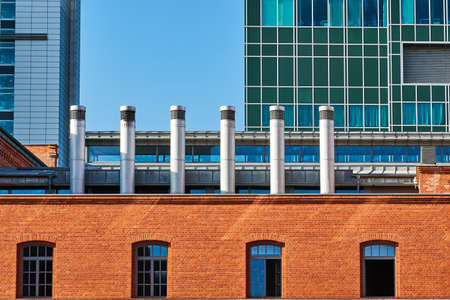 Fragments of modern office buildings. Old brick wall in Poznanの写真素材