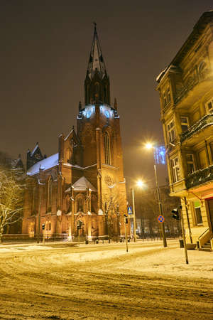 Facade and belfry of a neo-Gothic church during the winter in Poznanの写真素材