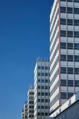 The facade of a modernist skyscrapers made of glass and aluminum in the center of Poznan