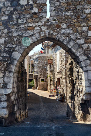 A medieval gate in a stone, historic defensive wall in the city of Ruoms in France