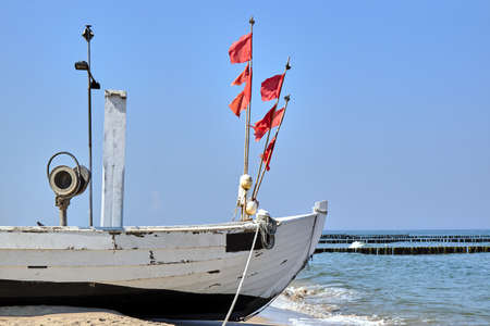 Wooden fishing boat on a sandy beach on the island of Usedom in Germany