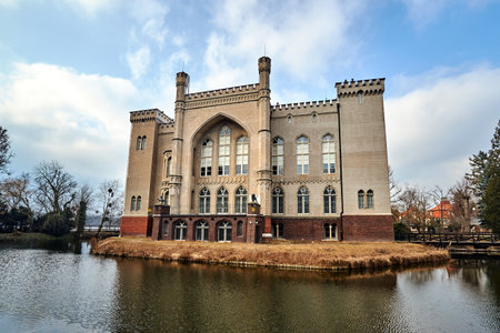 moat and the neo-gothic historic castle in the city of Kornik in Polandのeditorial素材