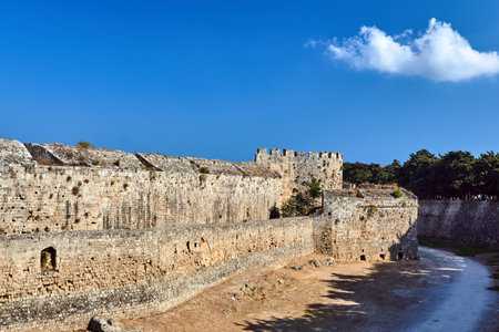 The moat and turrets of the medieval castle of the Joannite Order in the city of Rhodes