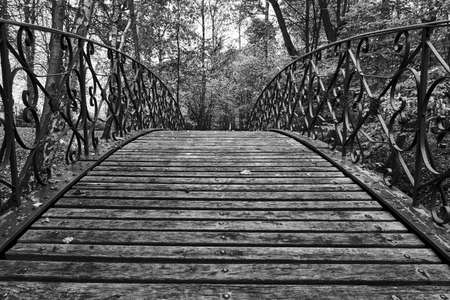 Wooden pedestrian bridge in a park in Poland, monochromeの写真素材