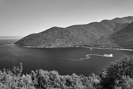 motor boat in the bay of the Ionian Sea a on the island of Kefalonia in Greece, monochrome