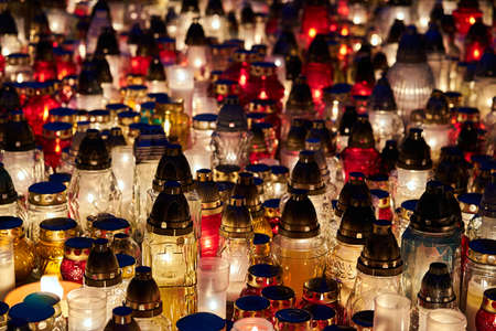 fires burning on a grave in the cemetery of All Saints' Day in Polandの写真素材