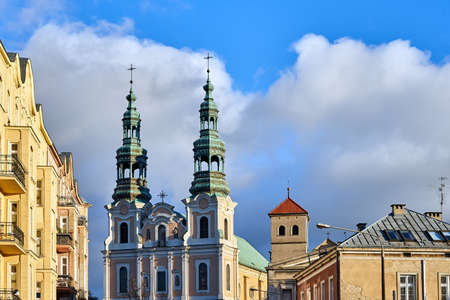Historic tenement houses and bell towers of a baroque church in the city of Poznanの写真素材