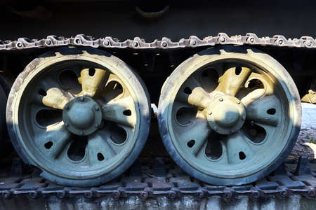 A caterpillar and road wheels of a historic Soviet tank from World War II in the city of Poznan