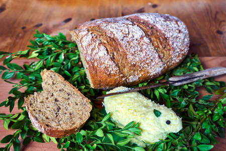 Loaf of bread, knife and Easter lamb made of butter on a wooden table in Poland