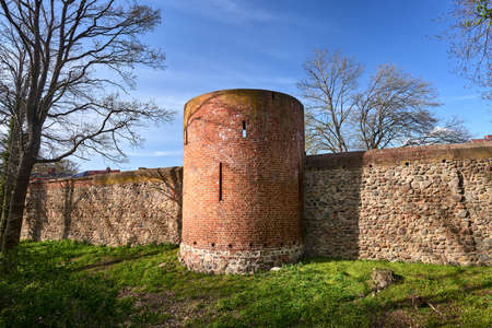 medieval fortifications with a round tower and a stone wall in Neuebrandemburg in Germanyの写真素材