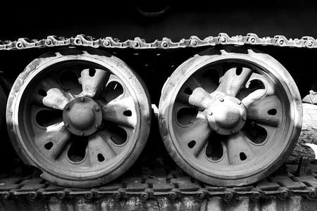 A caterpillar and road wheels of a historic Soviet tank from World War II in the city of Poznan, monochromeの写真素材