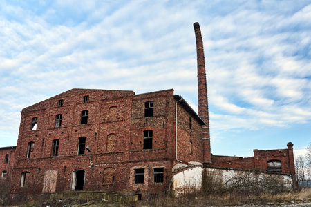Ruins of a historic brewery with a sloping brick chimney in Polandのeditorial素材