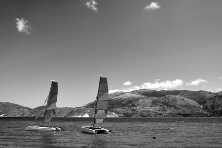 sailboats - catamaran moored in the sea bay on the island of Kefalonia in Greece, monochromeの写真素材