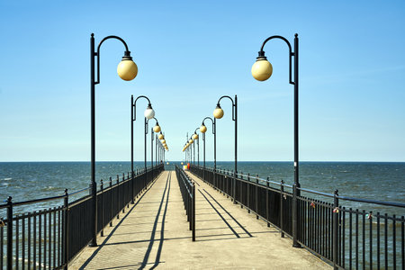 Lanterns on a concrete pier by the Baltic Sea in MiÄdzyzdroje, Polandの写真素材