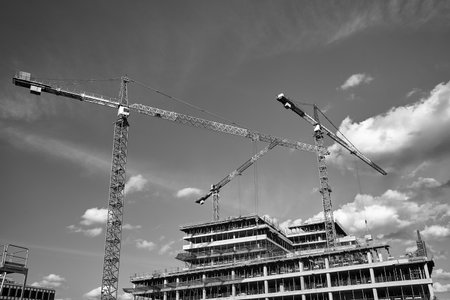 cranes at the construction site of an office buildingg in Poznan, monochromeの写真素材