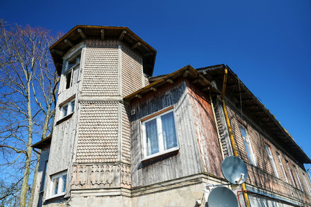 A historic wooden house with a satellite dish in the city of MiÄdzyzdroje, Polandの写真素材