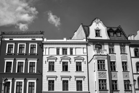 facades of a historic tenement houses in the city of Torun, Poland, monochrome