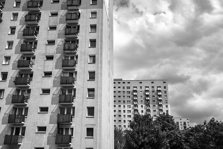The facade with balconies of a residential high-rise buildings in Poznan, Poland, monochrome