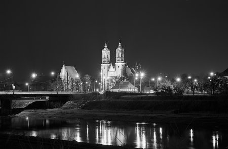 bridge over the river Warta and gothic cathedral at night in Poznan in Poland, monochromeの写真素材