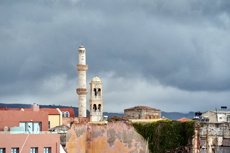 roofs of houses, minaret and the bell tower of the church in the city of Chania on the island of Crete, Greeceの写真素材