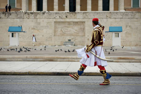 Soldier in traditional Greek uniform marching in front of the Parliament buildingのeditorial素材
