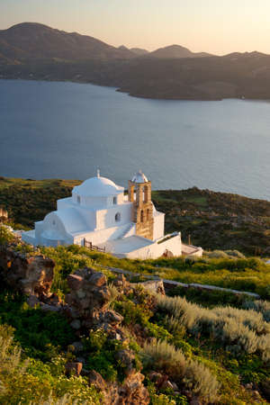 Small white church at the sunset with view of the seaの写真素材
