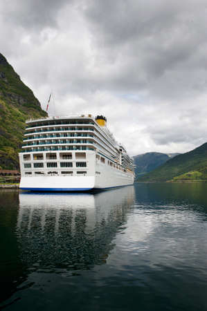 Big luxury cruise liner in the port of Flam reflecting in still clear waters of the fjord, Norwayのeditorial素材