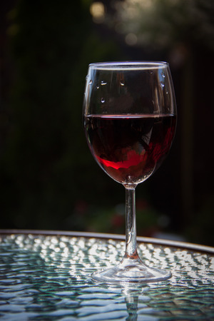 One glass of wine standing on the table.の写真素材